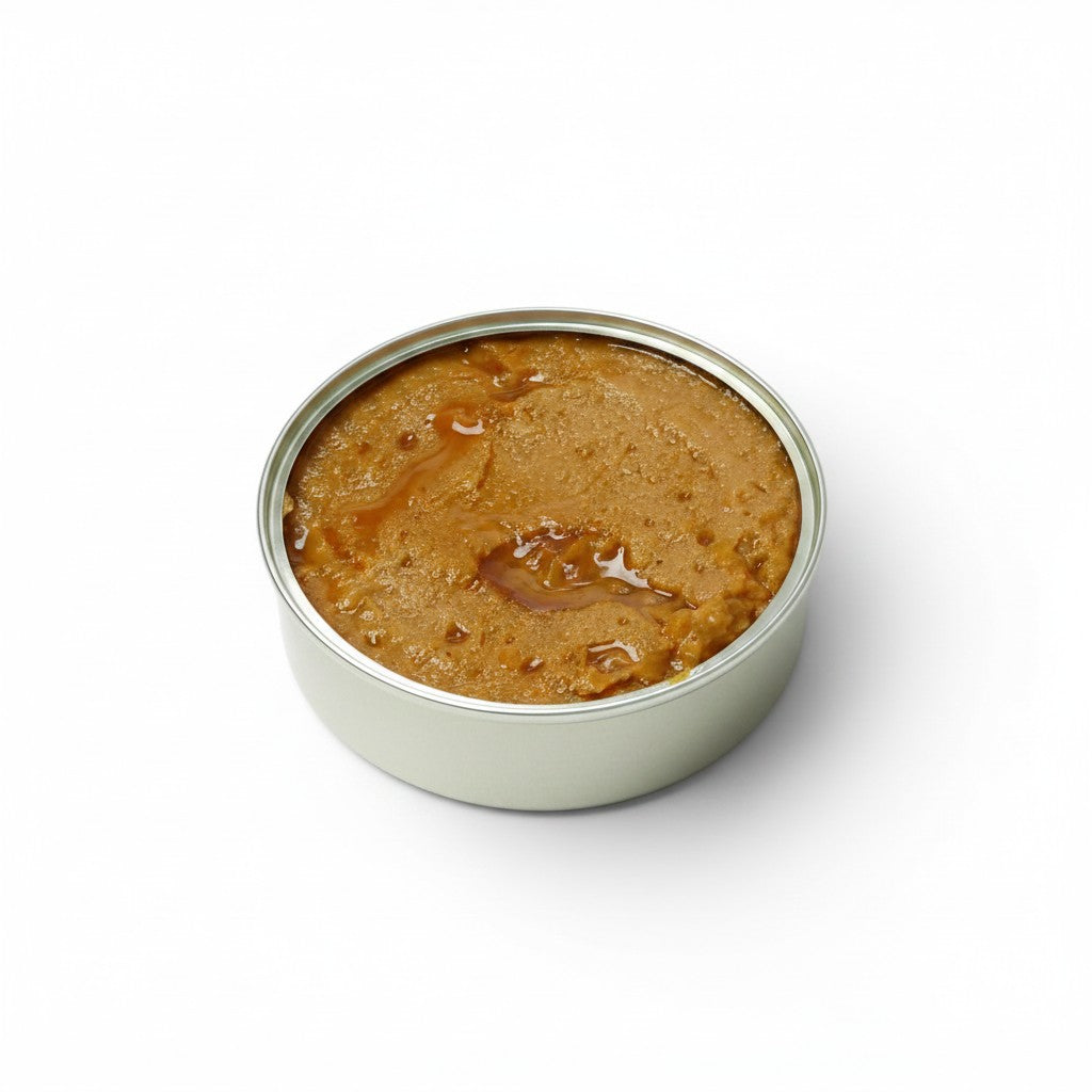 Tinned Fins José Gourmet trout pâté in an open round tin, featuring a smooth, golden-brown spreadable texture.